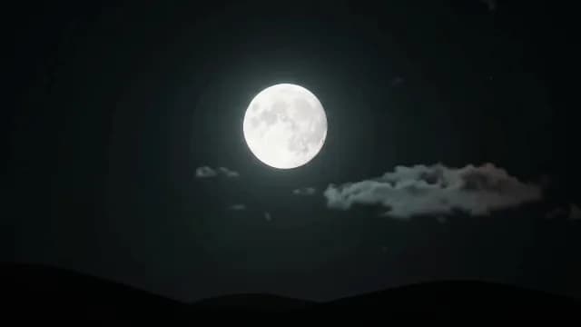 Bright Full Moon Shining in a Dark Night Sky with Clouds