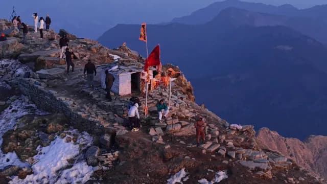 Pilgrims and Trekkers at a Mountain Top Hindu Temple in Chandrashila Peak and Himalayan Mountains in Chopta, Uttarakhand