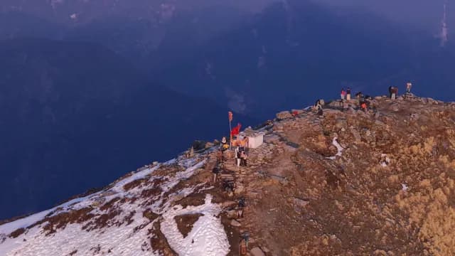 Hikers and Pilgrims at Chandrashila Peak and Himalayan Mountains in Chopta, Uttarakhand Mountain Summit During Golden Hour
