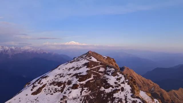 Hikers Standing on Snowy Chandrashila Peak and Himalayan Mountains in Chopta, Uttarakhand Peak at Sunrise