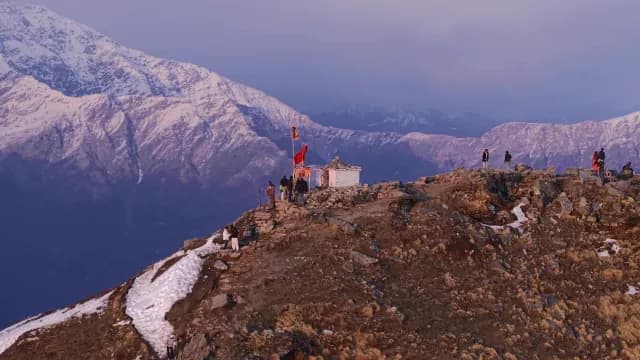 Hikers at Chandrashila Peak Temple During Sunset in the Chandrashila Peak and Himalayan Mountains in Chopta, Uttarakhand