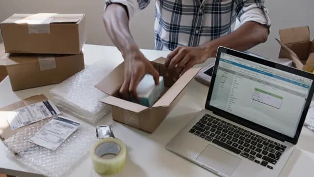 Small Business Owner Packing E-commerce Orders for Shipping and Delivery