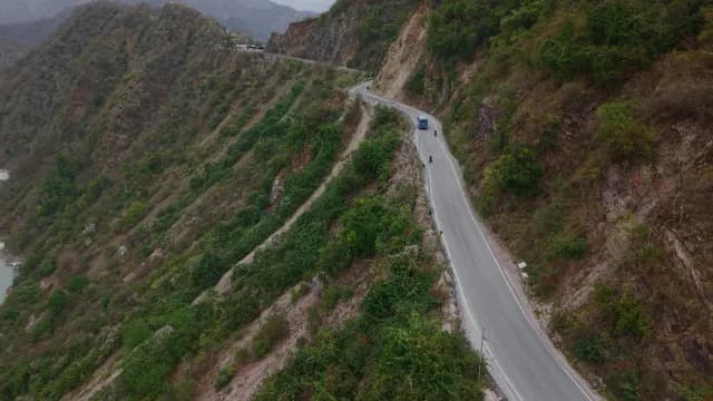 Scenic Drone Shot of Winding Himalayan Highway and Lush Green Mountains