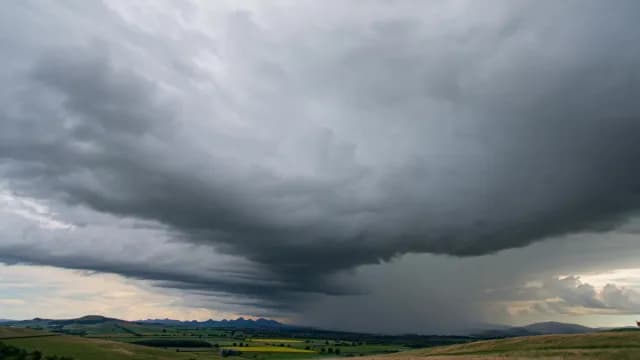 Dramatic Storm Clouds and Rain Over Rural Landscape