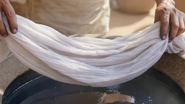 Artisan Hands Preparing White Fabric for Traditional Indigo Dyeing Process