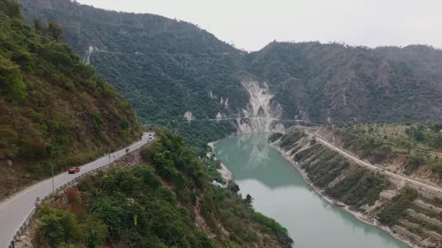 Aerial View of Winding Mountain Road Overlooking a Turquoise Alaknanda River Rudraprayag Road Uttarakhand
