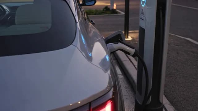 Modern Electric Car Charging at Public Station During Evening
