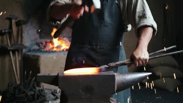 Blacksmith Hammering Glowing Hot Metal on Anvil in Traditional Forge