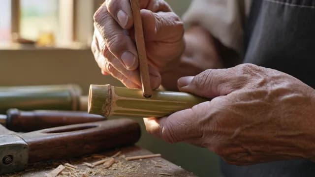 Close-up of Artisan Hands Carving Traditional Bamboo Craft