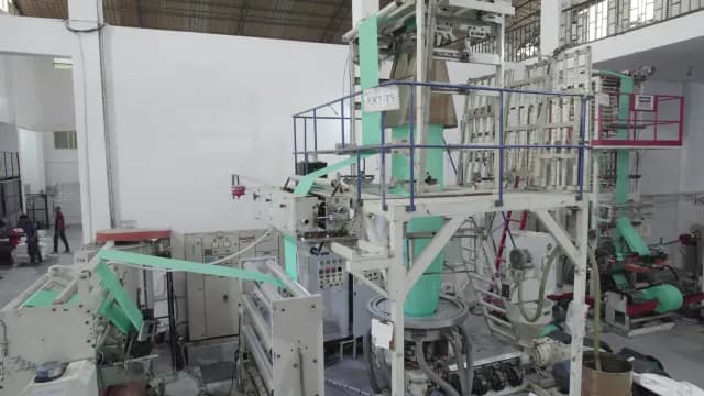 Industrial Plastic Film Extrusion Machine Operating in a Manufacturing Factory
