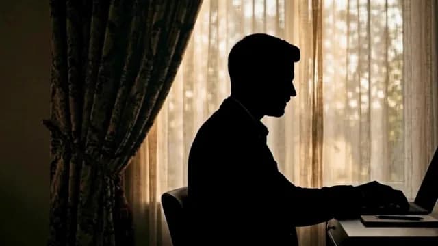 Silhouette of a Professional Man Working on Laptop in Home Office
