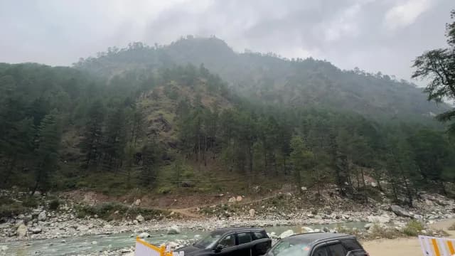 Scenic Misty Mountain Landscape with River and Pine Trees at Parvati River Dam, Barshaini Village in Kasol