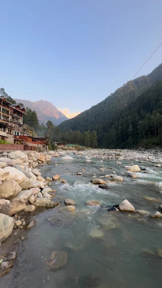 Scenic Mountain Parvati River Flowing Through a Peaceful Himalayan Village at Sunset