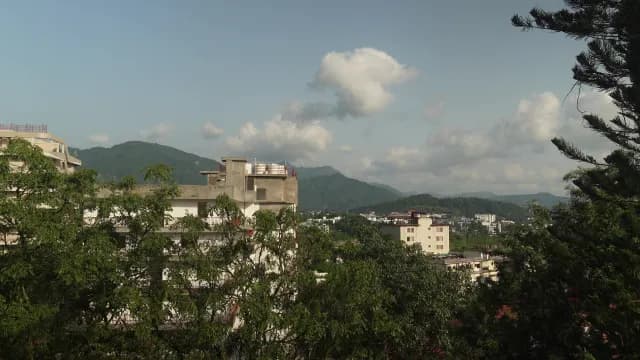 Scenic Urban Landscape Nestled in Lush Green Mountain Foothills at Jakhan Road, Dehradun