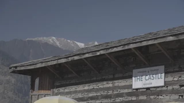 Historic Naggar Castle with Snow-Capped Himalayan Mountains in Himachal Pradesh