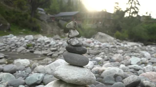 Balanced Zen Stone Stack on Rocky Riverbed at Golden Hour