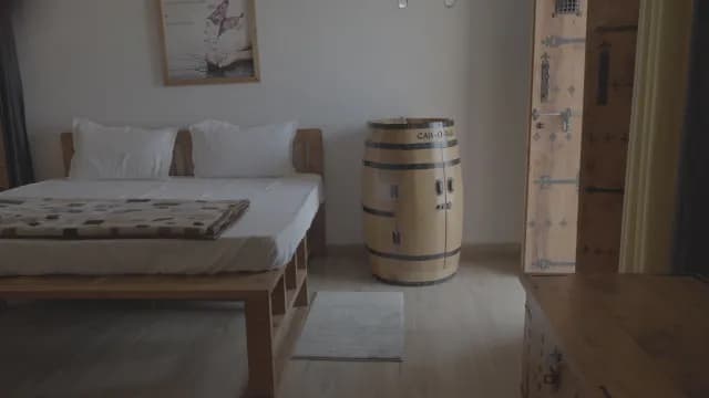 Rustic Bedroom Interior Featuring a Unique Wooden Barrel Cabinet