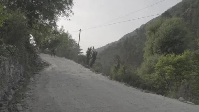 Dusty Mountain Tirthan Valley Road Winding Through Lush Green Forest