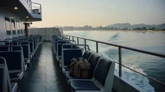 Empty Ferry Deck Sailing Near Coastal Shore at Sunrise