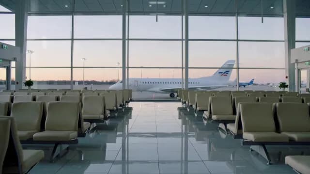 Modern Airport Departure Lounge Overlooking Private Jet at Dusk