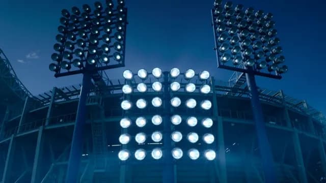Bright Stadium Floodlights Shining at Night in Sports Arena