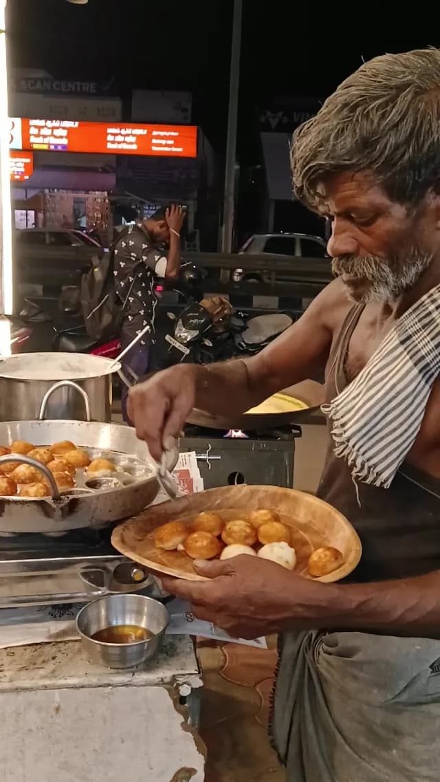 Indian Street Food Vendor Preparing Fresh Paniyaram at Night Market