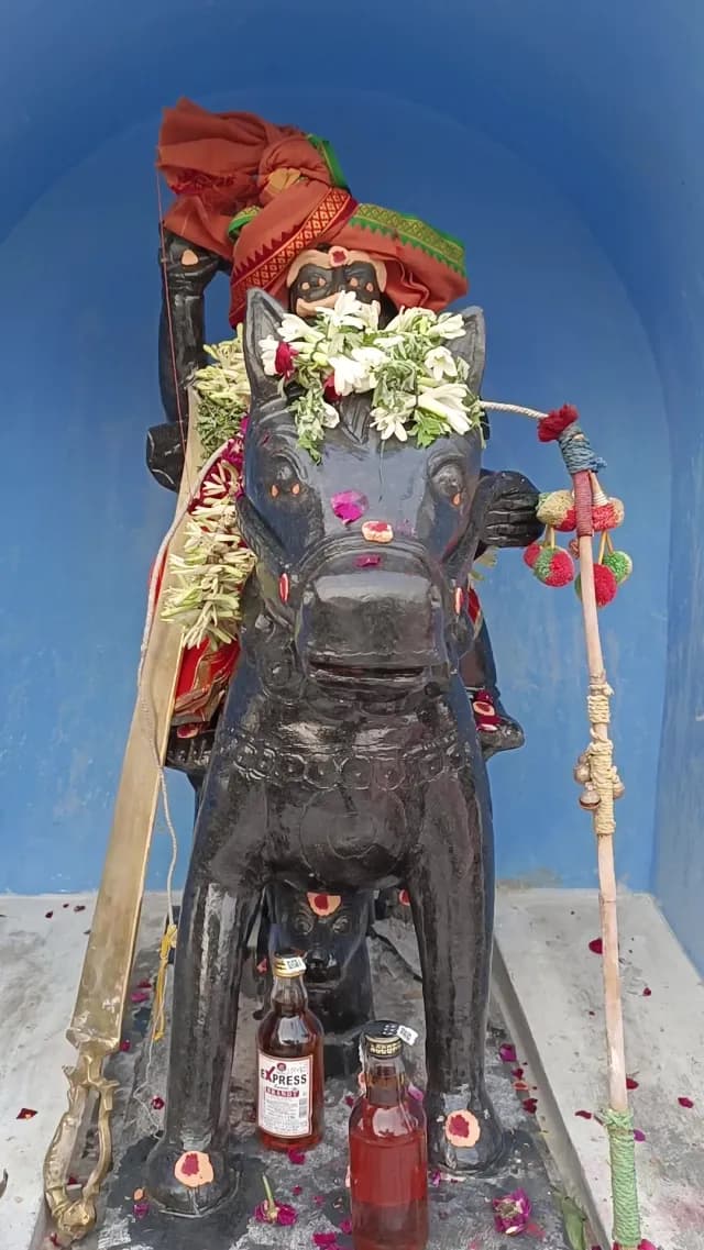 Karuppasamy Statue with Ritual Offerings and Flowers