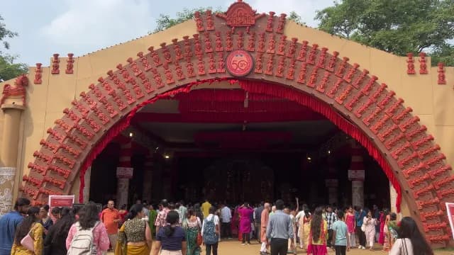 Crowds Entering Ornate Durga Puja Pandal During Celebration in Delhi