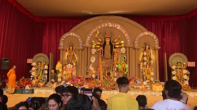 Grand Durga Puja Celebration with Ornate Goddess Idol and Devotees