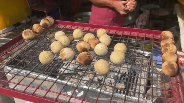 Traditional Indian Litti Chokha Roasting on a Charcoal Grill