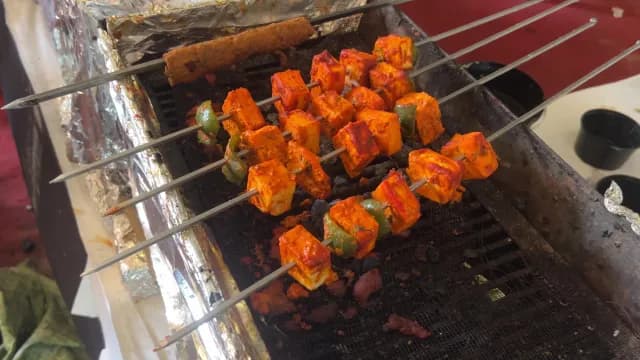 Paneer Tikka and Seekh Kebab Grilling on a Traditional Charcoal Grill