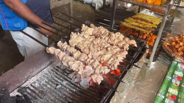 Chicken Kebabs Grilling Over Hot Charcoal at a Street Food Market