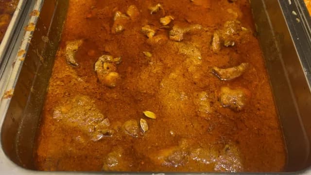 Spicy Traditional Meat Curry in a Stainless Steel Buffet Tray
