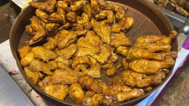 Golden Fried Chicken Wings and Drumsticks in a Large Metal Tray