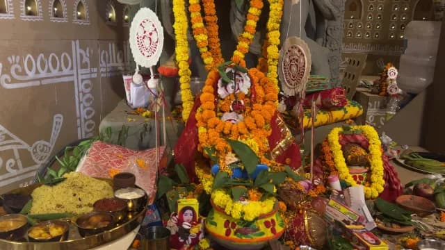 Traditional Hindu Puja Setup with Marigold Garlands and Religious Offerings