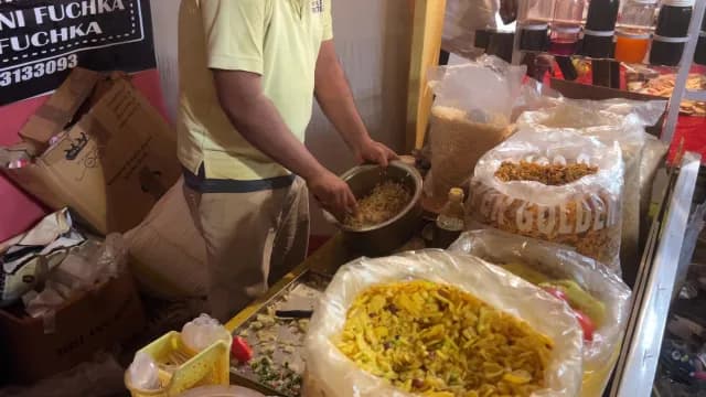 Indian Street Food Vendor Mixing Traditional Savory Snacks in Large Bowl, Durga Puja Festival